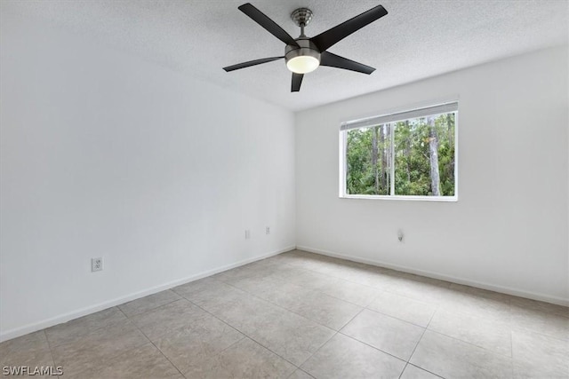 tiled spare room featuring ceiling fan and a textured ceiling