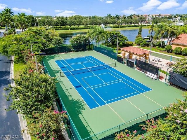 view of sport court with a water view