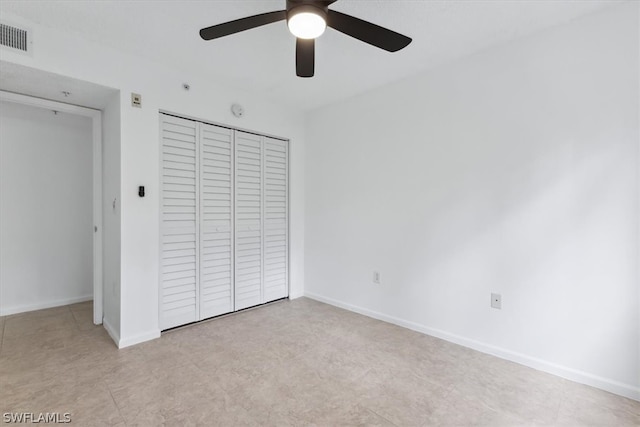 unfurnished bedroom with a closet, ceiling fan, and light tile patterned floors