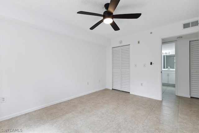 interior space featuring light tile patterned flooring, a closet, sink, and ceiling fan