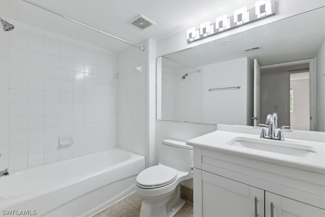 full bathroom with tiled shower / bath combo, vanity, tile patterned floors, and toilet