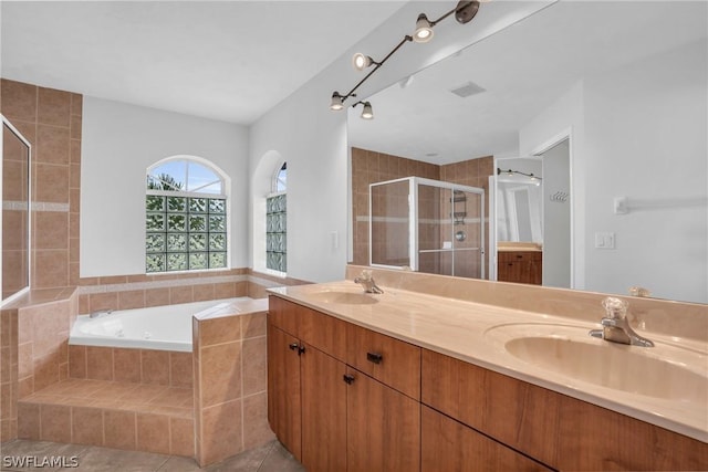 bathroom featuring vanity, tile patterned flooring, and plus walk in shower