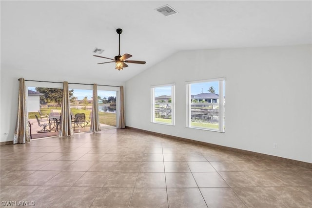 tiled empty room with lofted ceiling and ceiling fan