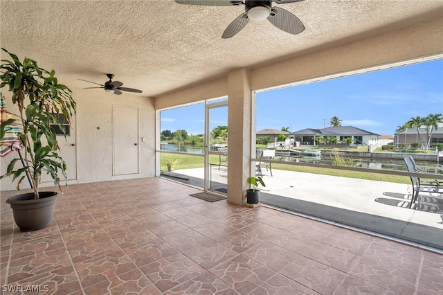 view of patio / terrace with a water view and ceiling fan