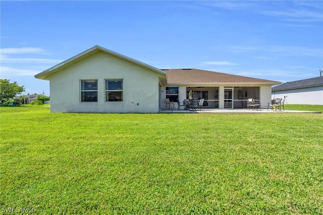 rear view of property featuring a patio area and a lawn