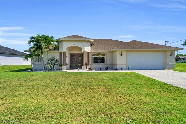 view of front of property with a front yard and a garage