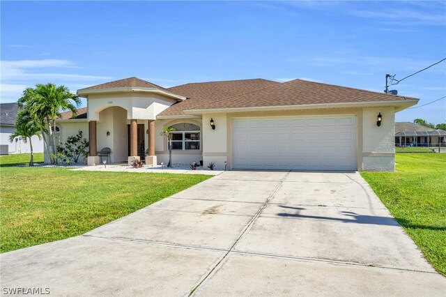 view of front of house featuring a front yard and a garage