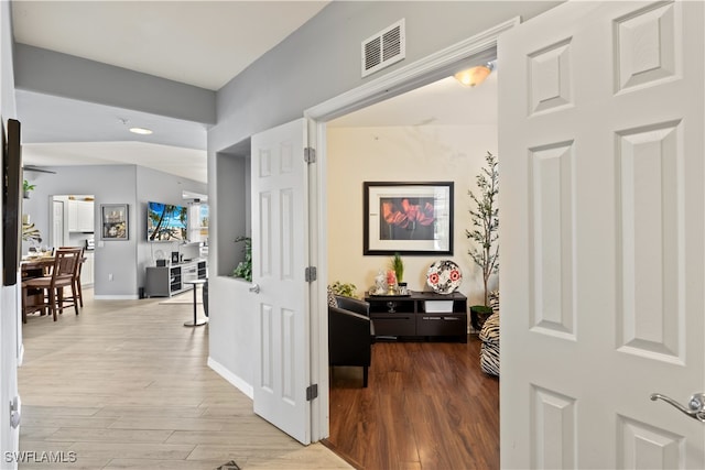 hallway with light hardwood / wood-style floors