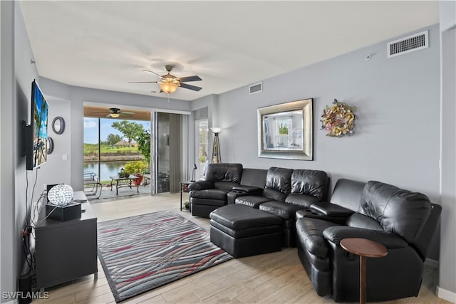 living room featuring ceiling fan and light hardwood / wood-style flooring