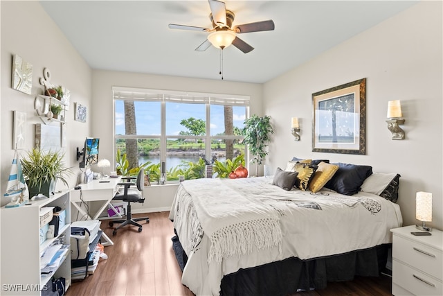 bedroom with ceiling fan and wood-type flooring