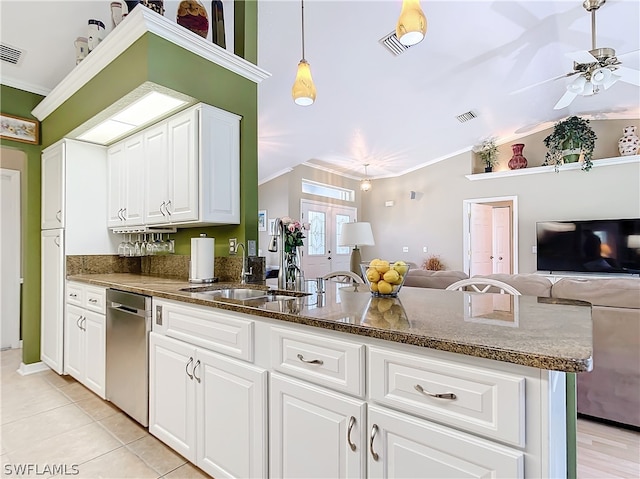 kitchen featuring sink, kitchen peninsula, stainless steel dishwasher, crown molding, and white cabinetry