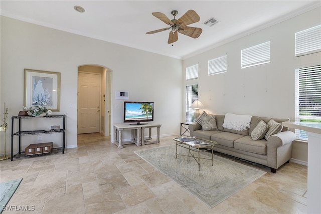 living room featuring ceiling fan and crown molding