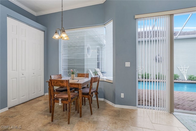 dining area with ornamental molding and an inviting chandelier