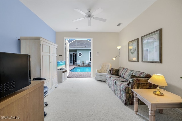 carpeted living room featuring ceiling fan