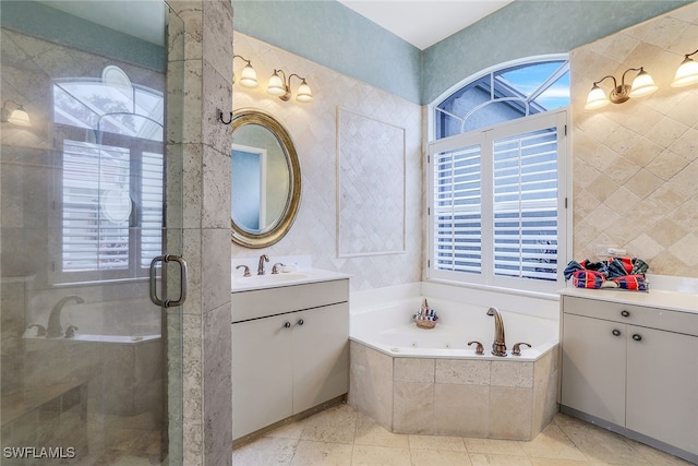 bathroom with vanity and shower with separate bathtub