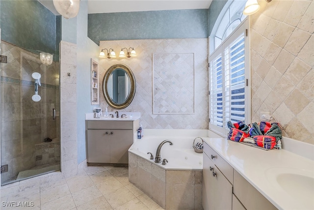 bathroom with vanity and shower with separate bathtub