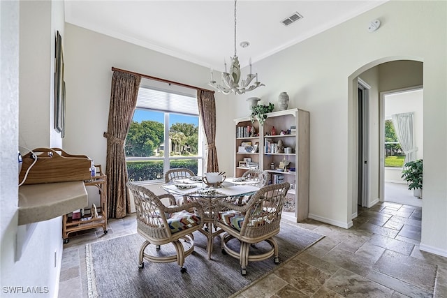 dining space featuring a notable chandelier and ornamental molding