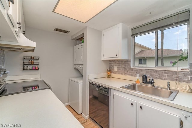 kitchen with stacked washer / drying machine, sink, white cabinetry, tasteful backsplash, and dishwasher