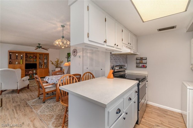 kitchen with electric stove, white cabinetry, kitchen peninsula, and pendant lighting