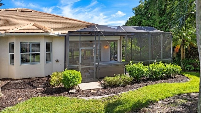 rear view of property with glass enclosure