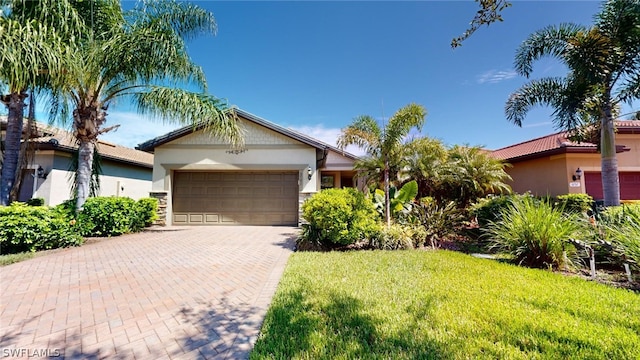 view of front of property with a garage and a front yard