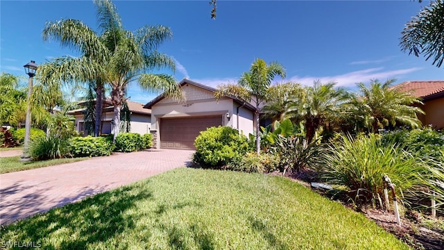 view of front of property featuring a garage and a front yard