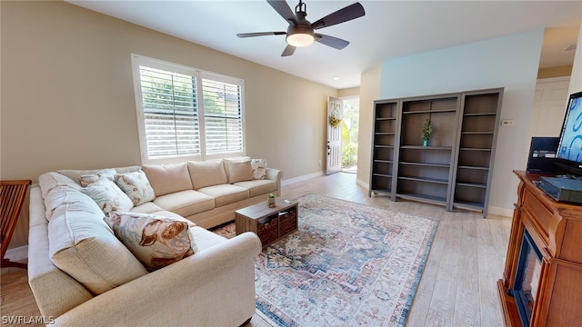 living room with light hardwood / wood-style floors and ceiling fan