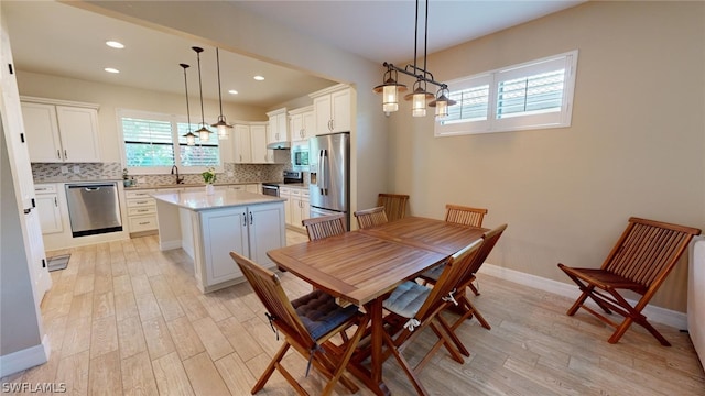 dining space featuring light hardwood / wood-style floors and sink