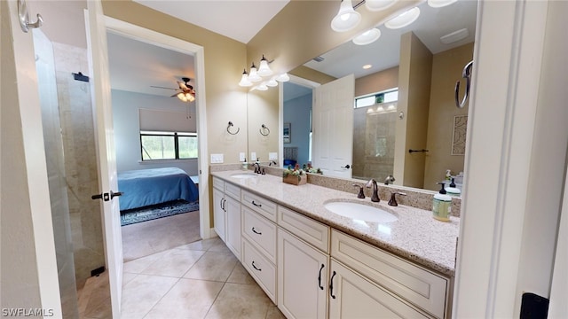 bathroom featuring a tile shower, dual vanity, tile patterned floors, and ceiling fan