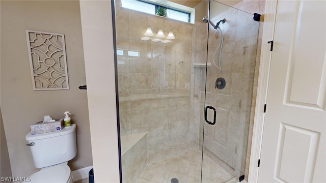 bathroom with toilet and an enclosed shower