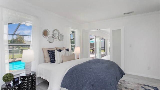 bedroom with hardwood / wood-style flooring and ornamental molding