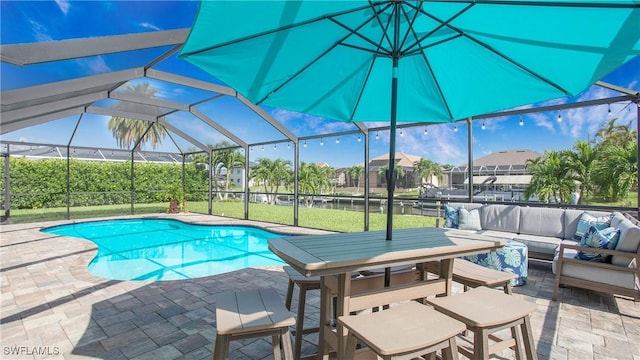 view of pool featuring an outdoor living space, a lanai, and a patio area