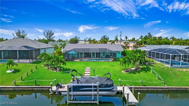 rear view of property featuring a water view, a lanai, and a lawn