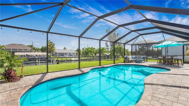 view of pool featuring an outdoor hangout area, a patio area, a lawn, and glass enclosure