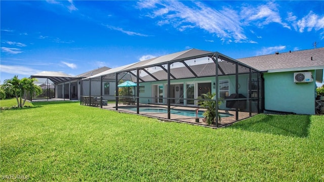 back of house featuring a lanai, a yard, a wall unit AC, and a patio area