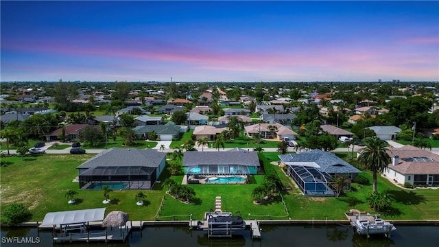 aerial view at dusk with a water view