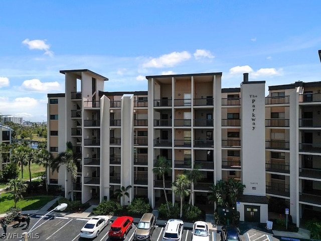 view of building exterior with uncovered parking