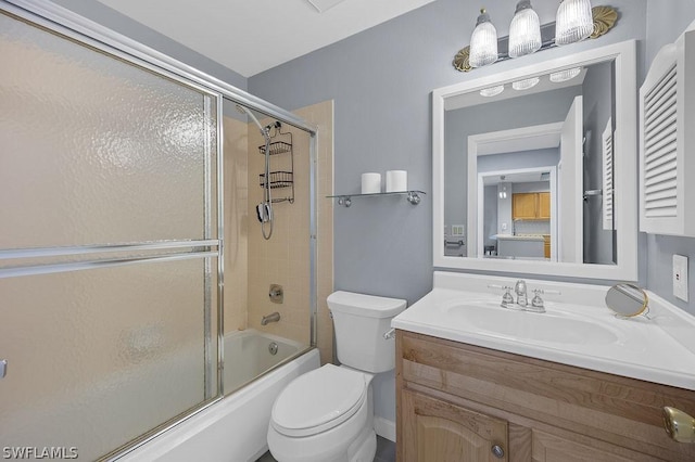 full bathroom featuring toilet, bath / shower combo with glass door, and vanity