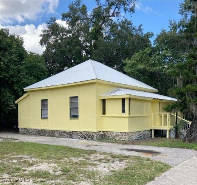 view of property exterior featuring metal roof and stucco siding