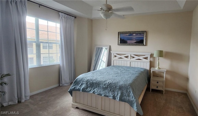 carpeted bedroom featuring a ceiling fan and baseboards