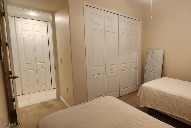 bedroom with two closets and carpet