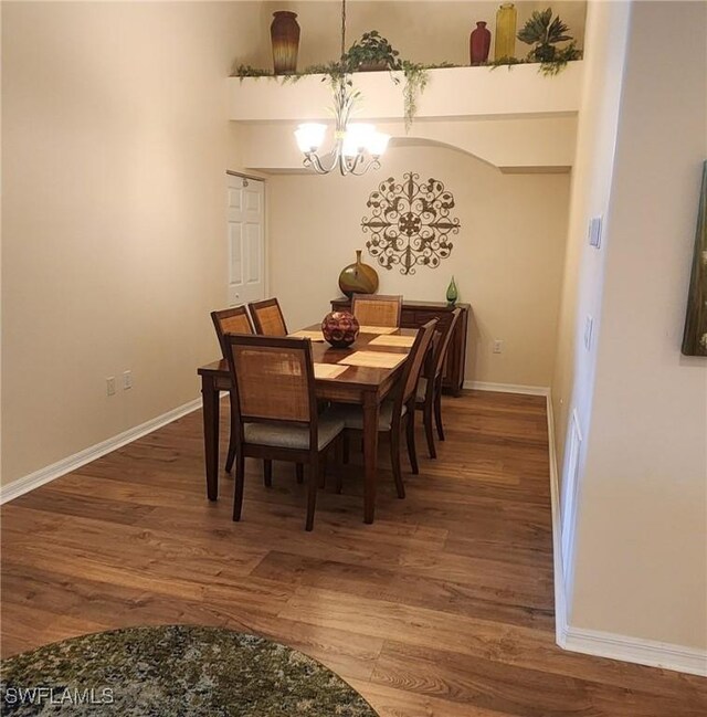 dining area with an inviting chandelier and hardwood / wood-style floors