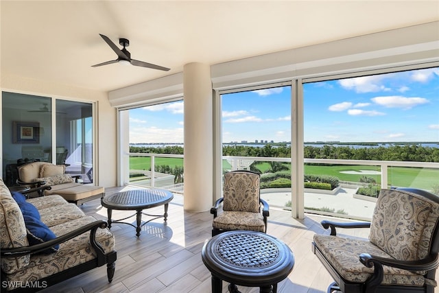 sunroom featuring ceiling fan