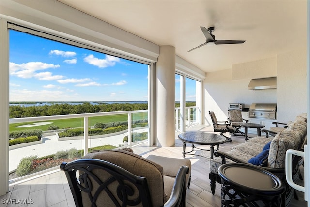 sunroom featuring ceiling fan