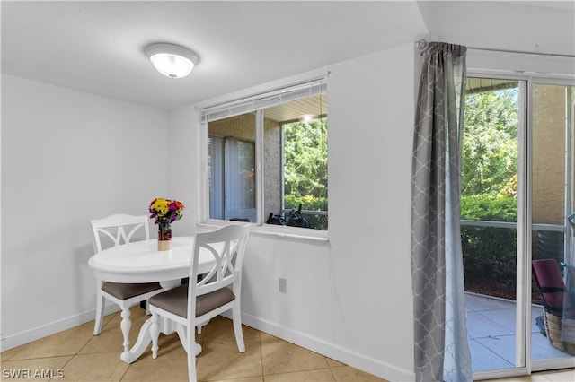 dining space with plenty of natural light and light tile patterned floors