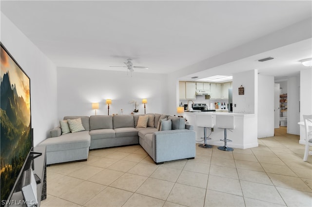 living room with light tile patterned flooring and ceiling fan