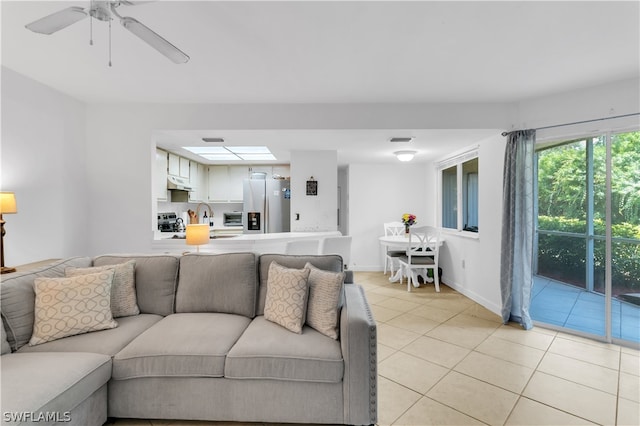 tiled living room featuring sink and ceiling fan