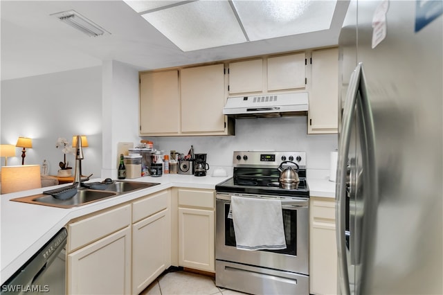 kitchen with light tile patterned flooring, sink, cream cabinets, and stainless steel appliances