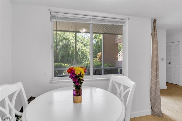 dining room featuring tile patterned flooring and a healthy amount of sunlight