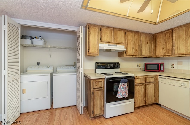 kitchen with light wood-type flooring, ceiling fan, white appliances, and a textured ceiling